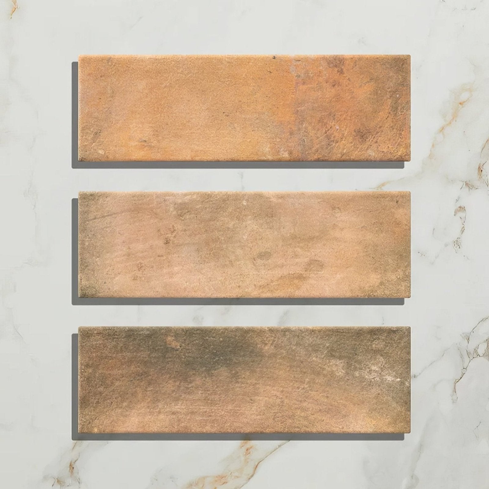 Three rectangular petite porcelain matt cotto dark tiles with rustic terracotta finish and warm brown tones