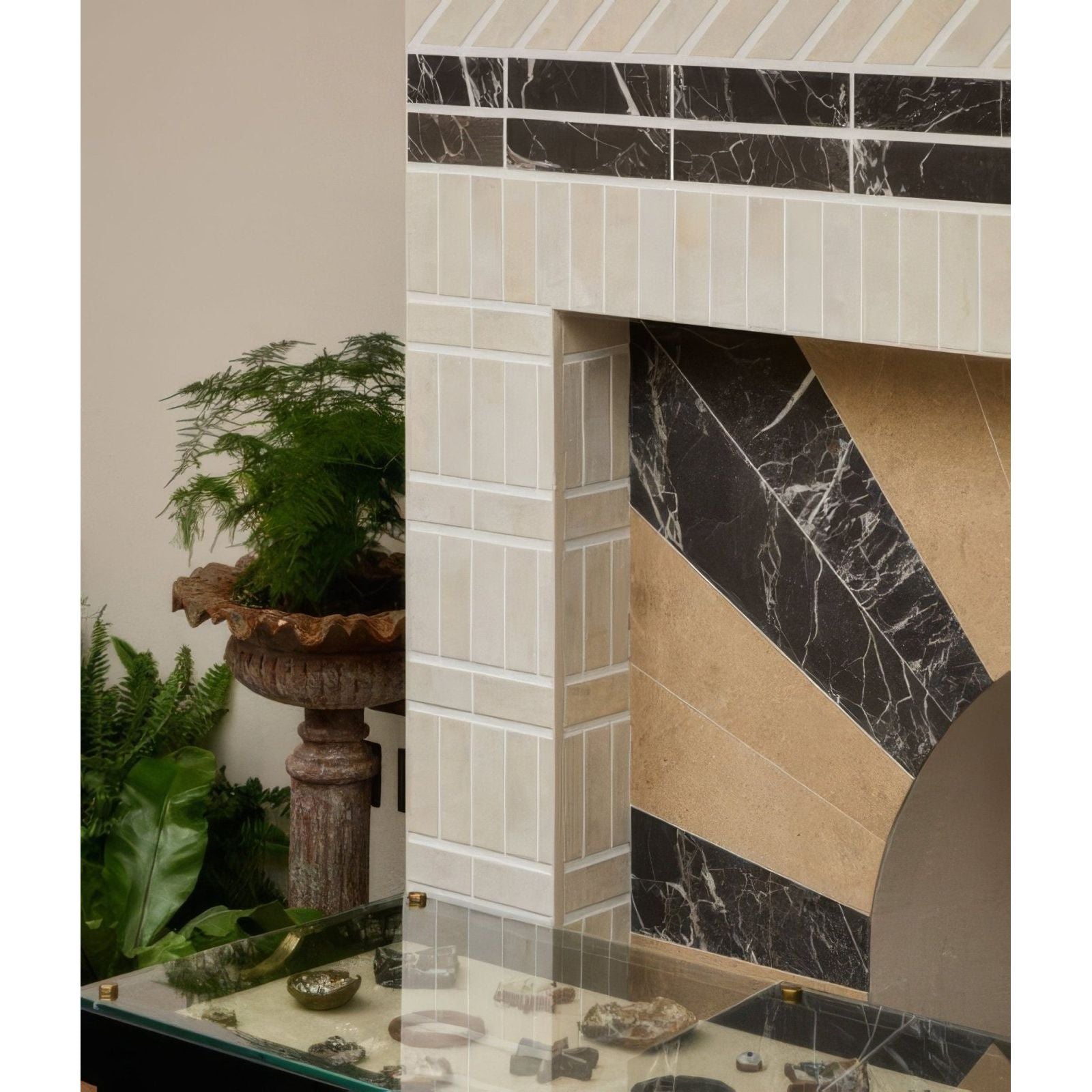 The petite porcelain matt cotto light fireplace features a geometric black and beige marble tile pattern framed by white tiles