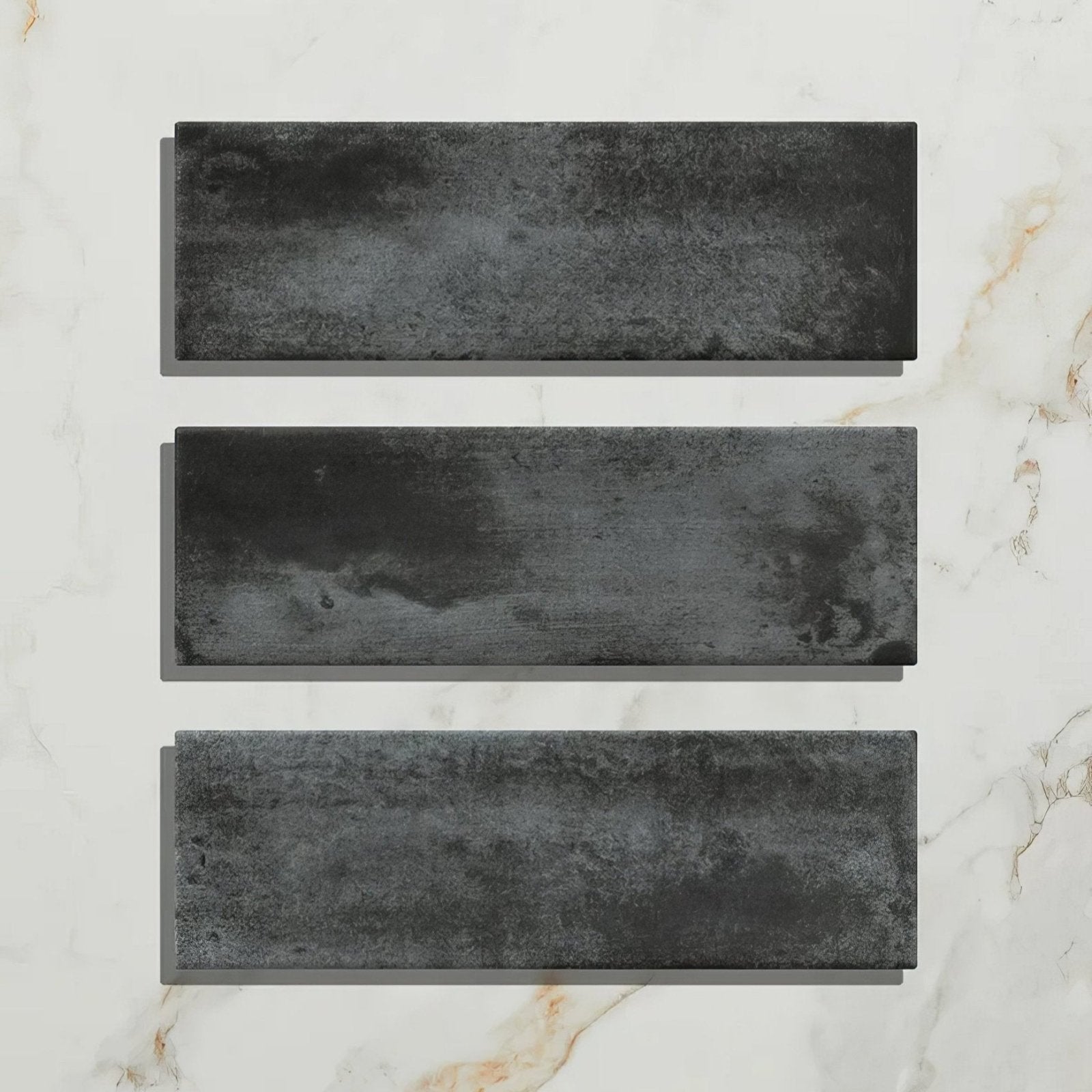 Three rectangular dark gray textured porcelain tiles with a rustic weathered finish from petite porcelain matt graphite collection