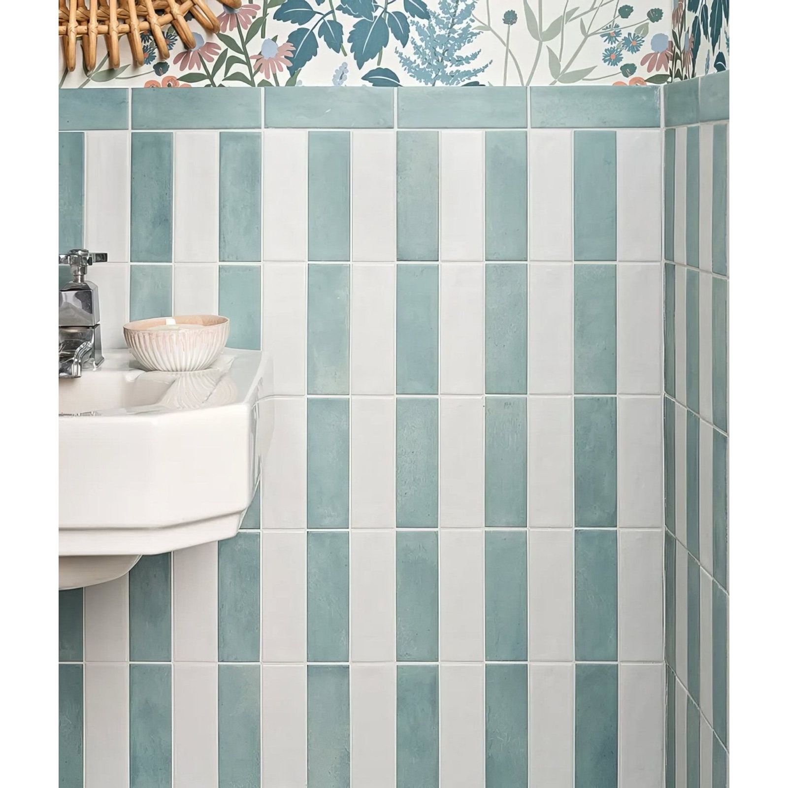 Vertical stripes of matte-finished teal and white petite porcelain matt white ceramic tiles on a bathroom wall