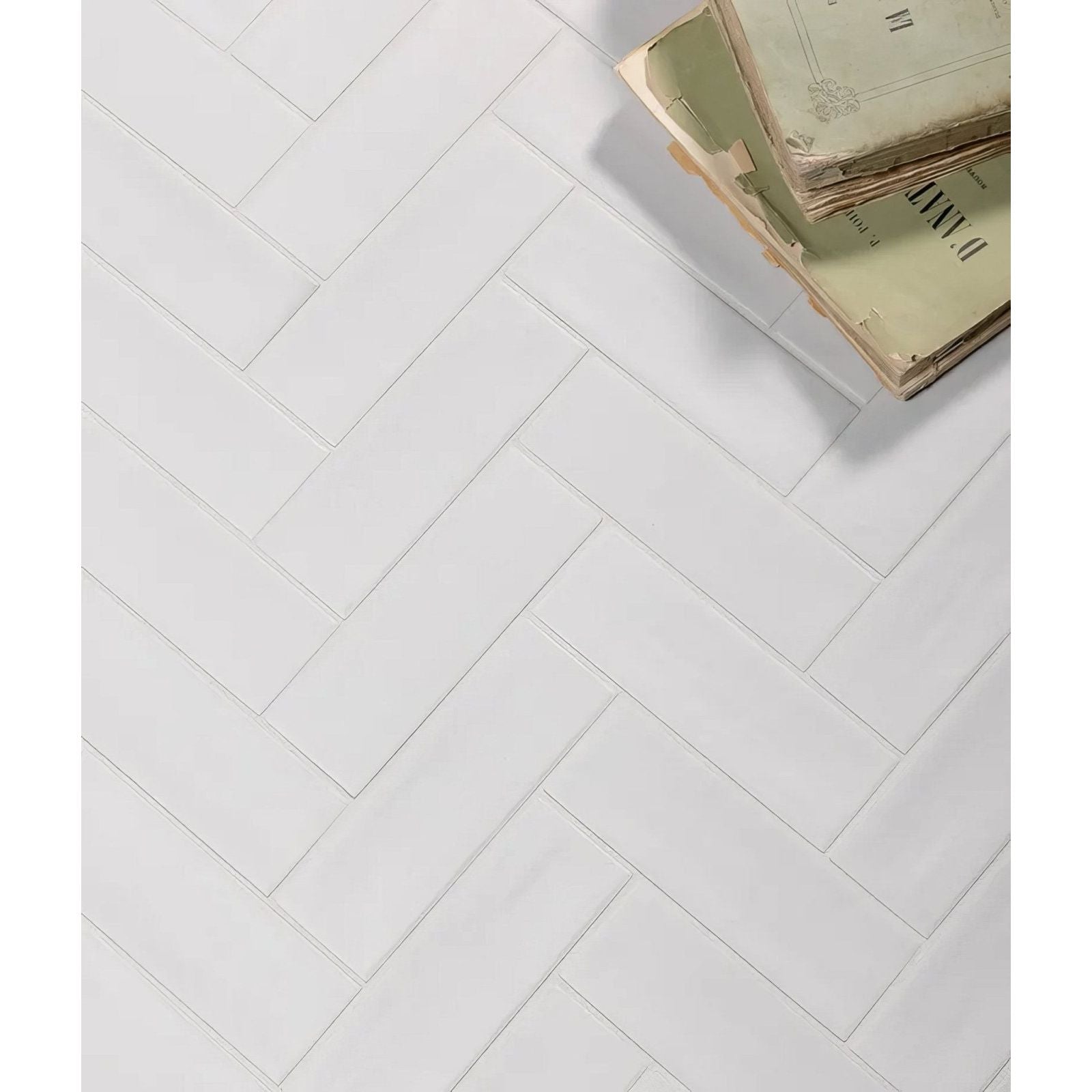 White rectangular porcelain matt tiles arranged in a herringbone pattern for wall or floor use