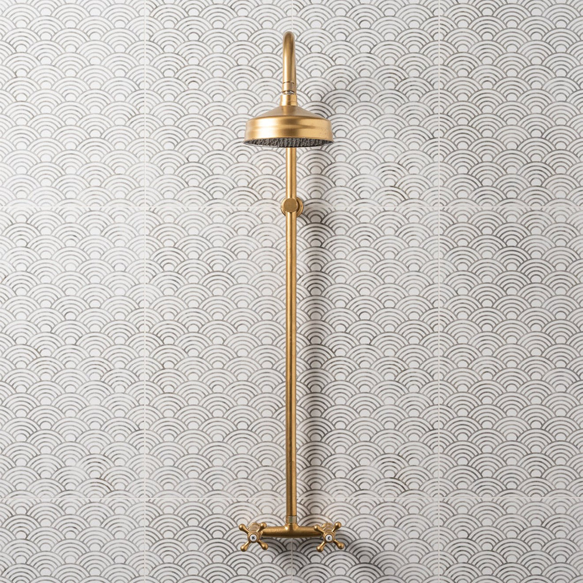 Palazzo Pettina 60x30cm grey and white patterned tiles with a brass showerhead