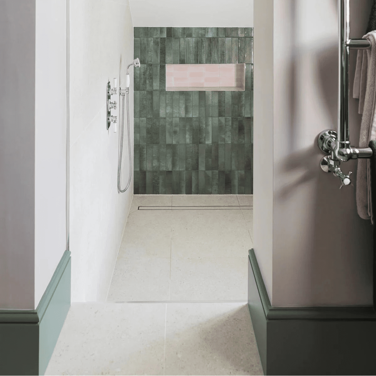 The piazza bone 60 x 60cm shower wall features sleek dark green rectangular tiles in a staggered pattern