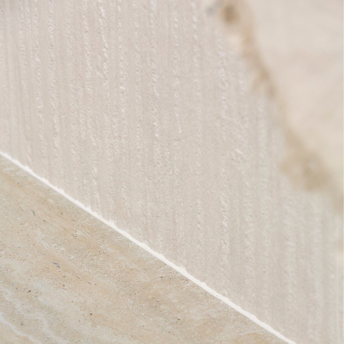 Beige textured porcelain wall tile with vertical ridges and subtle marbling called plastercraft linea mano porcelain ecru textured