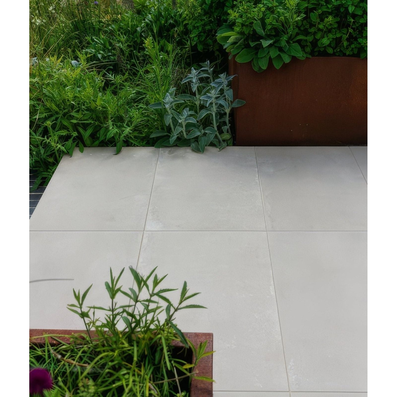 Light gray square porcelain patio tiles with smooth matte finish from béton chic paving textured collection