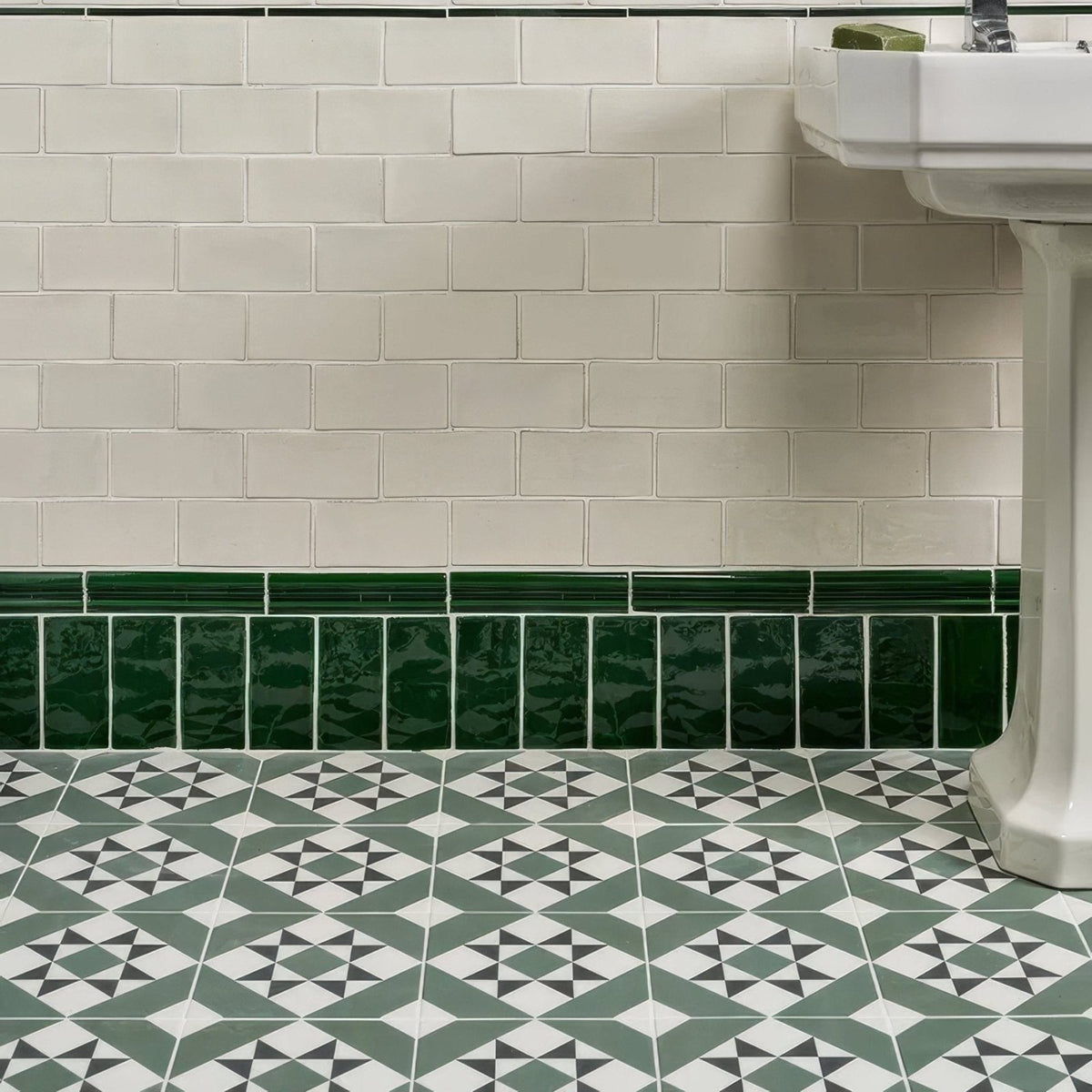 Brompton porcelain greenwich white glossy subway tiles with bold green porcelain border tile at the base of the wall