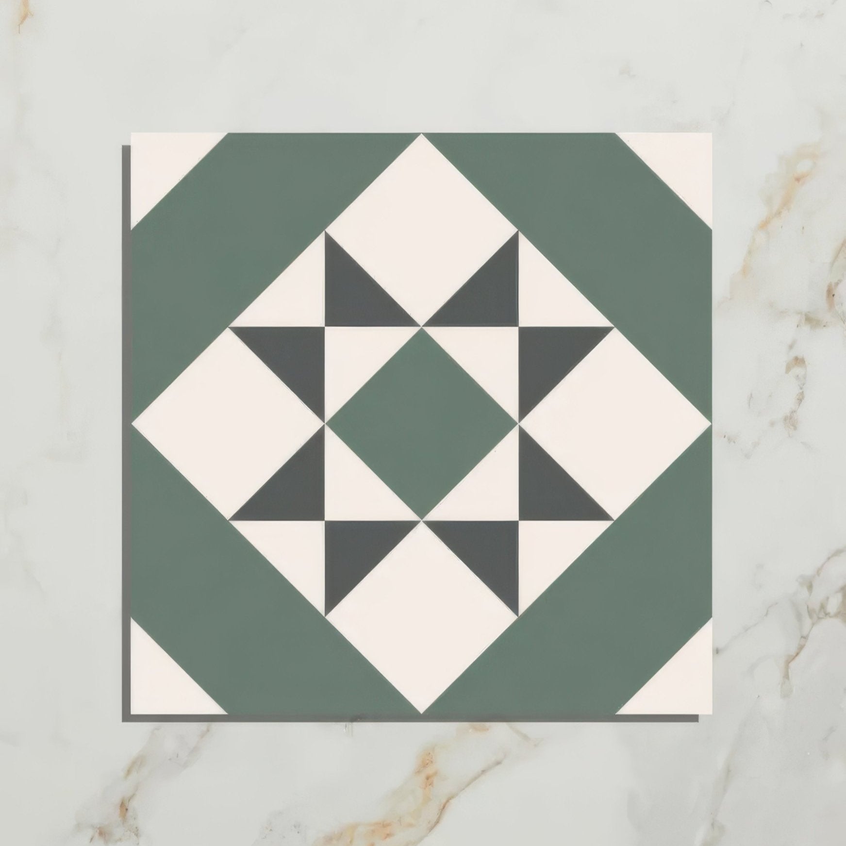 A square brompton porcelain greenwich mosaic tile with a geometric star pattern in sage green black and off-white