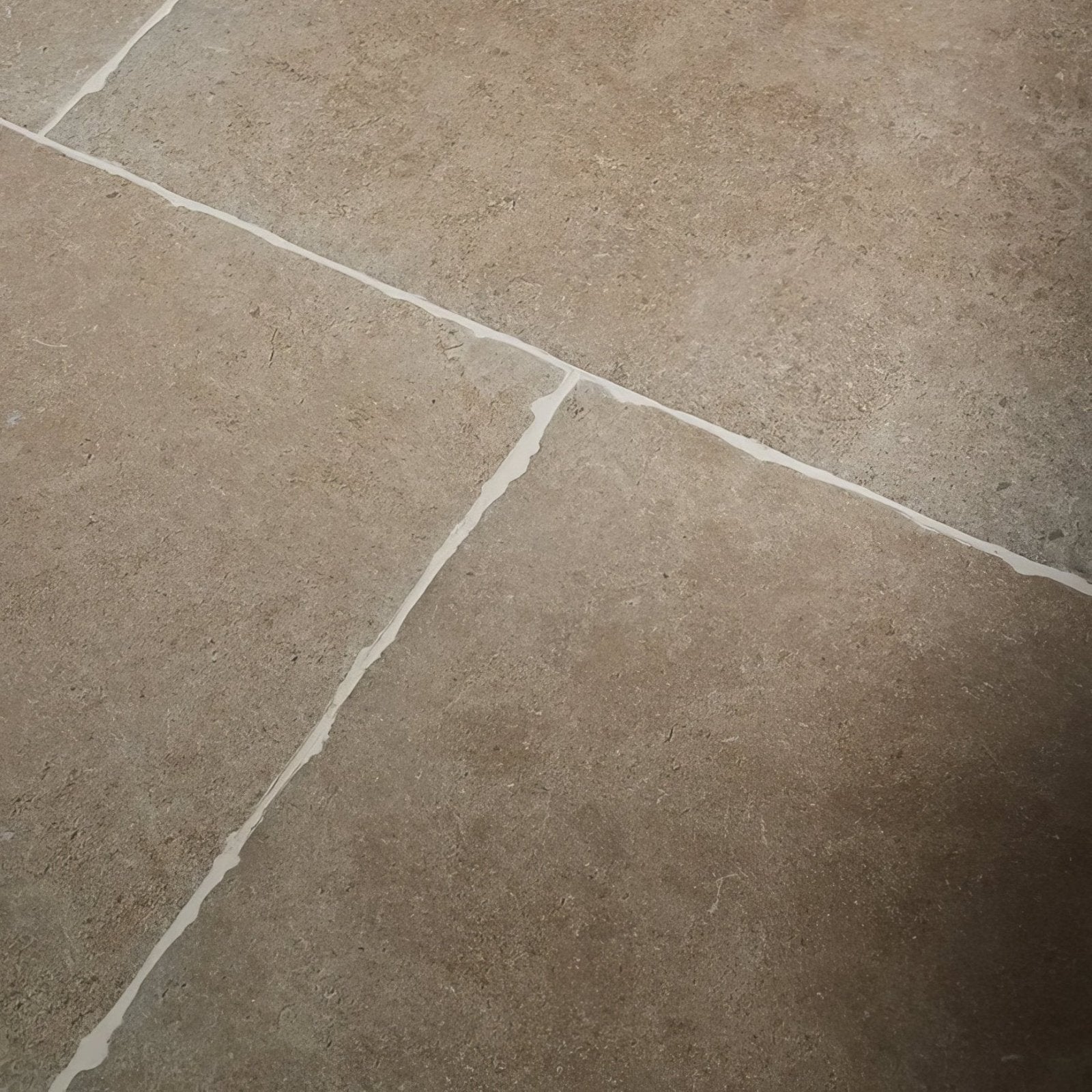 Beige cotswold porcelain matt stone tiles with subtle texture and white grout lines for flooring and walls