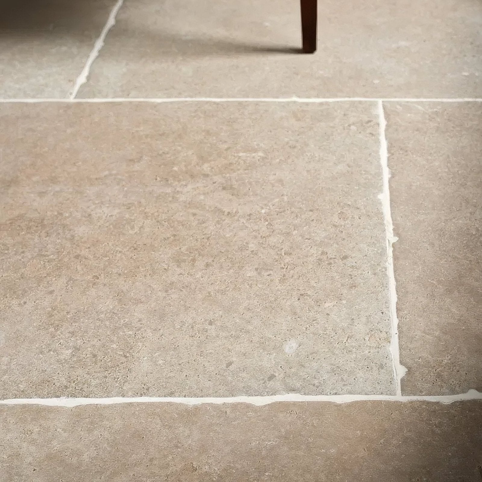 Beige cotswold porcelain matt stone tiles with subtle natural veining and white grout lines for flooring and walls
