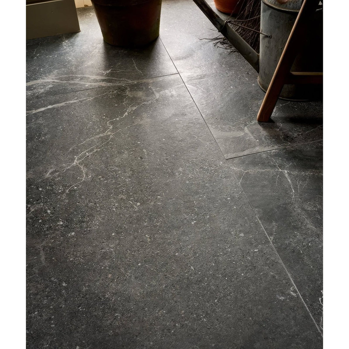 Etna porcelain matt floor tiles 59.5x59.5cm dark gray marble with subtle white veining and polished surface