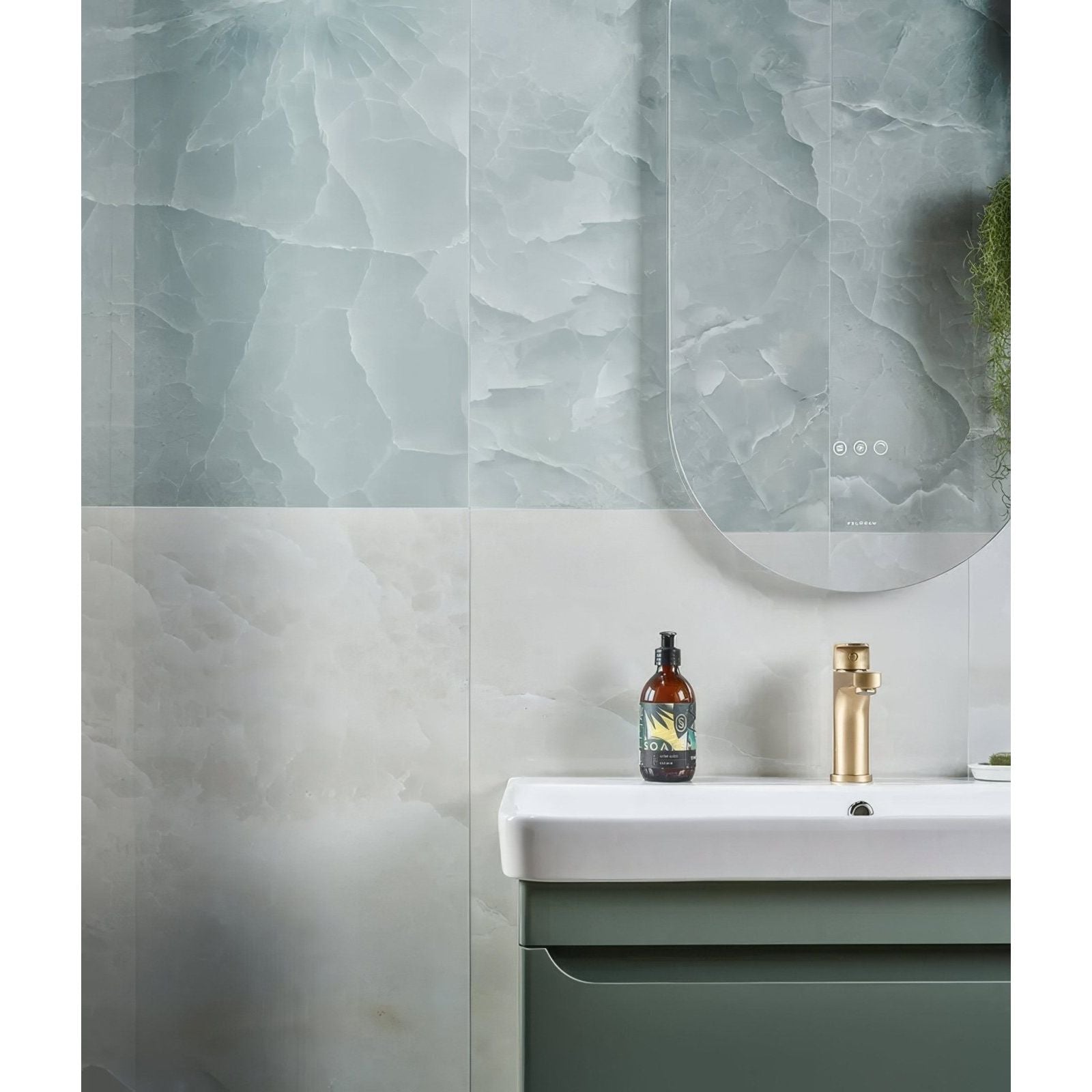illusion Whisper Onyx Porcelain Polished Mist white marble-effect tiles with a sink and gold tap