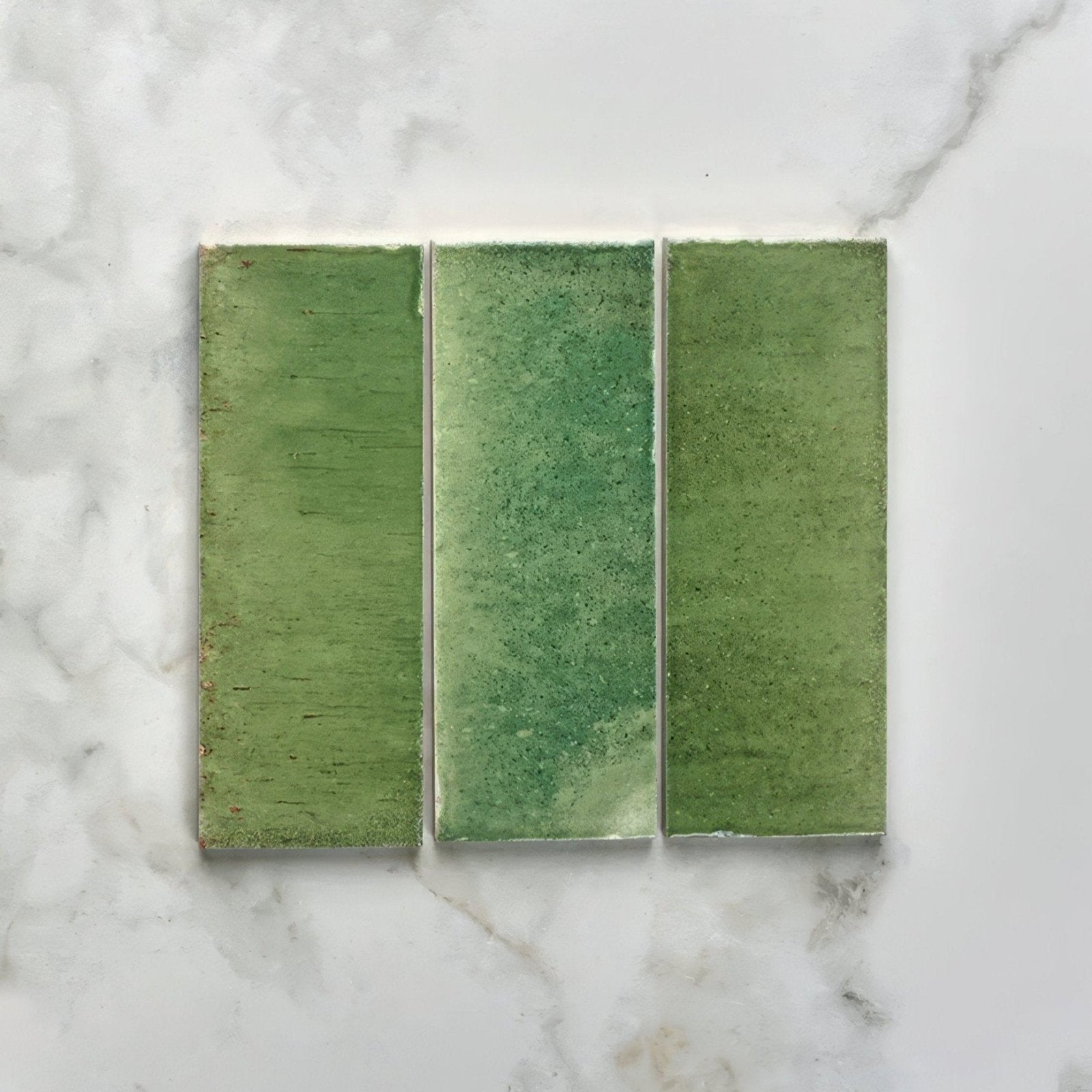 Three rectangular green pottery porcelain tiles with textured matte finish arranged side by side for brick use