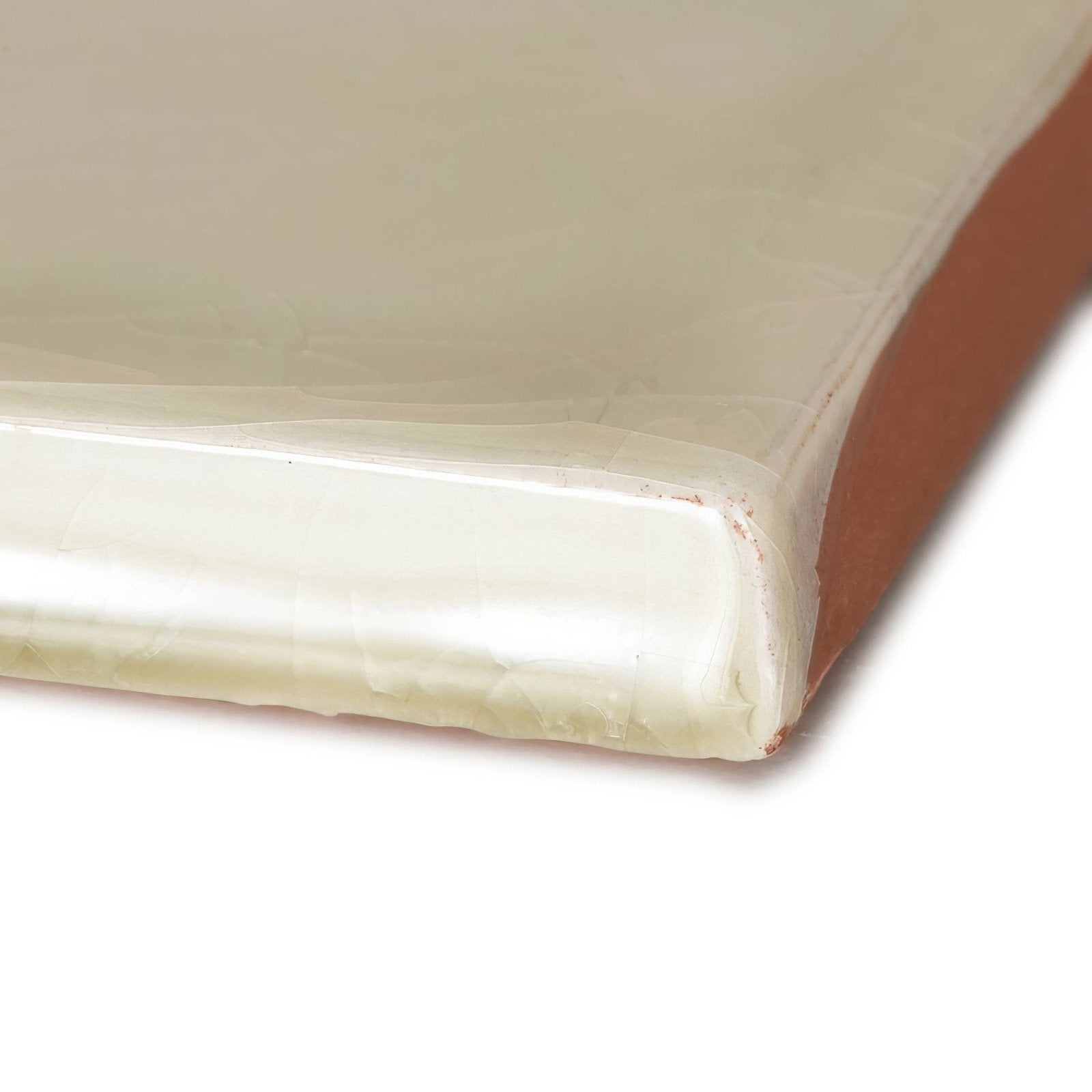 Cream-colored ceramic tile provencemiramar square with glossy finish and visible terracotta edge