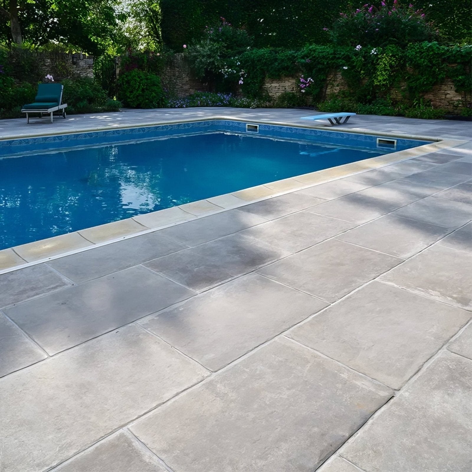 Rectangular light gray textured porcelain pool deck tiles from provence paving porcelain cenere collection