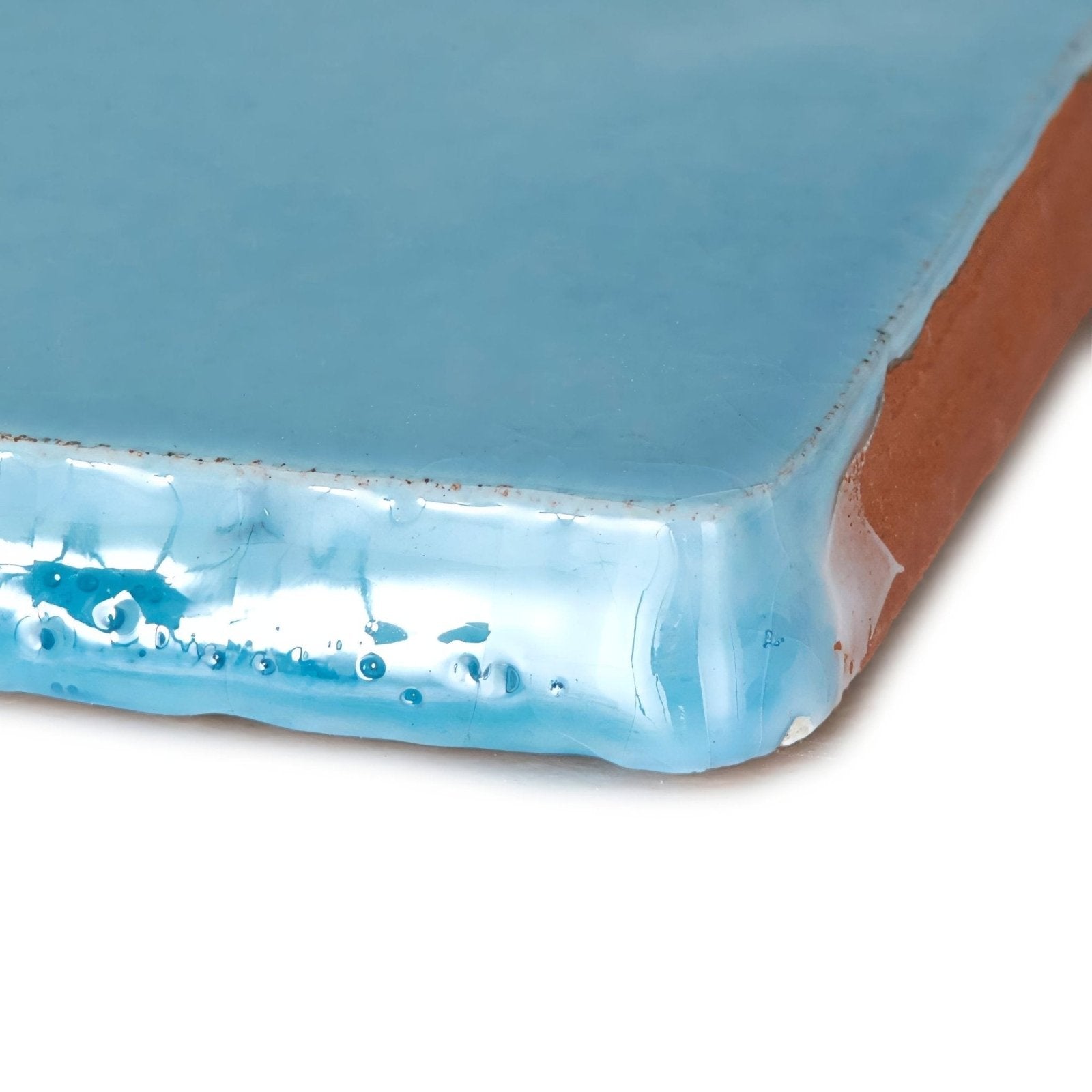 A square Provence Turbie rectangle ceramic tile with a glossy light blue glaze over terracotta base