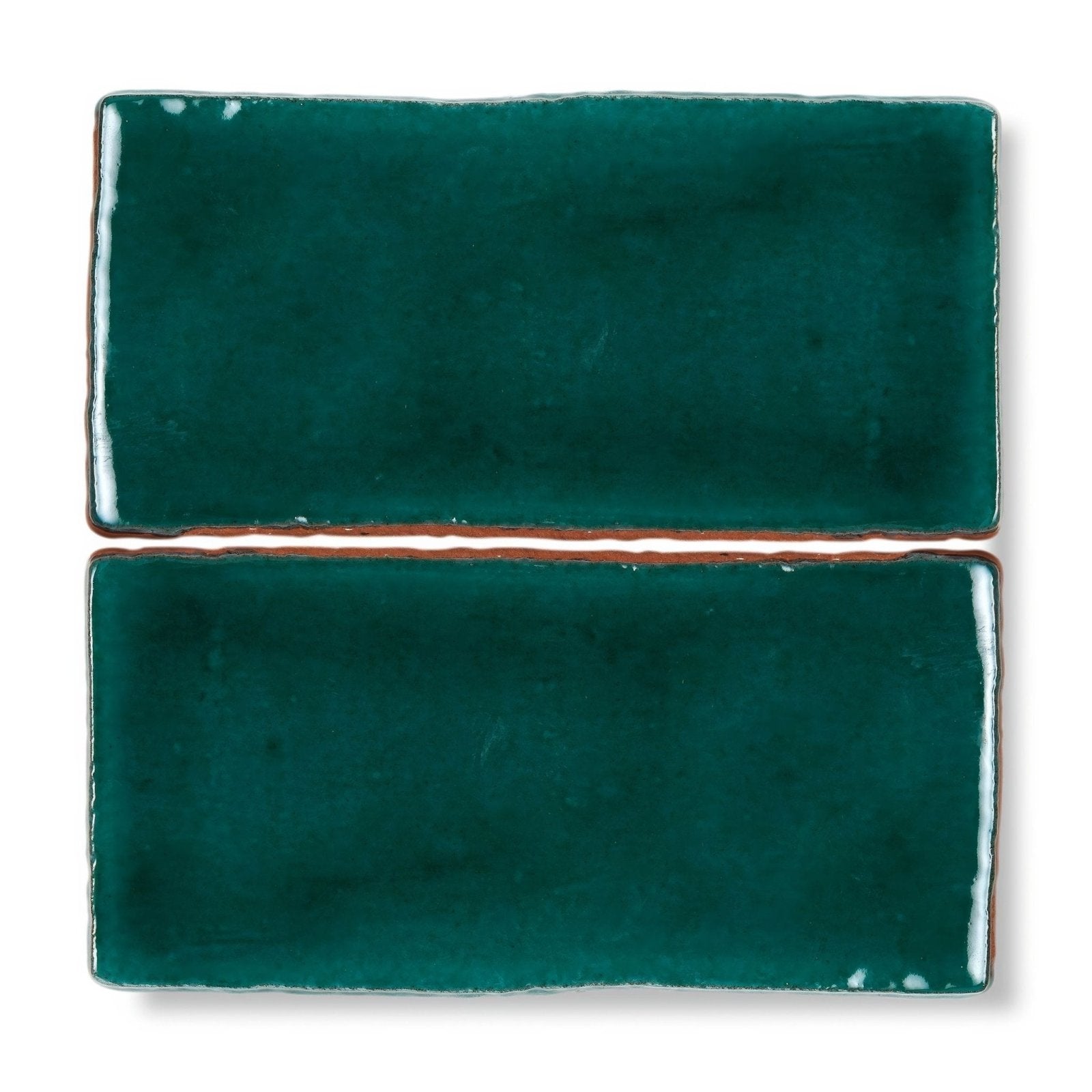 Two teal ceramic provence valette rectangle tiles with glossy finish and rustic uneven edges