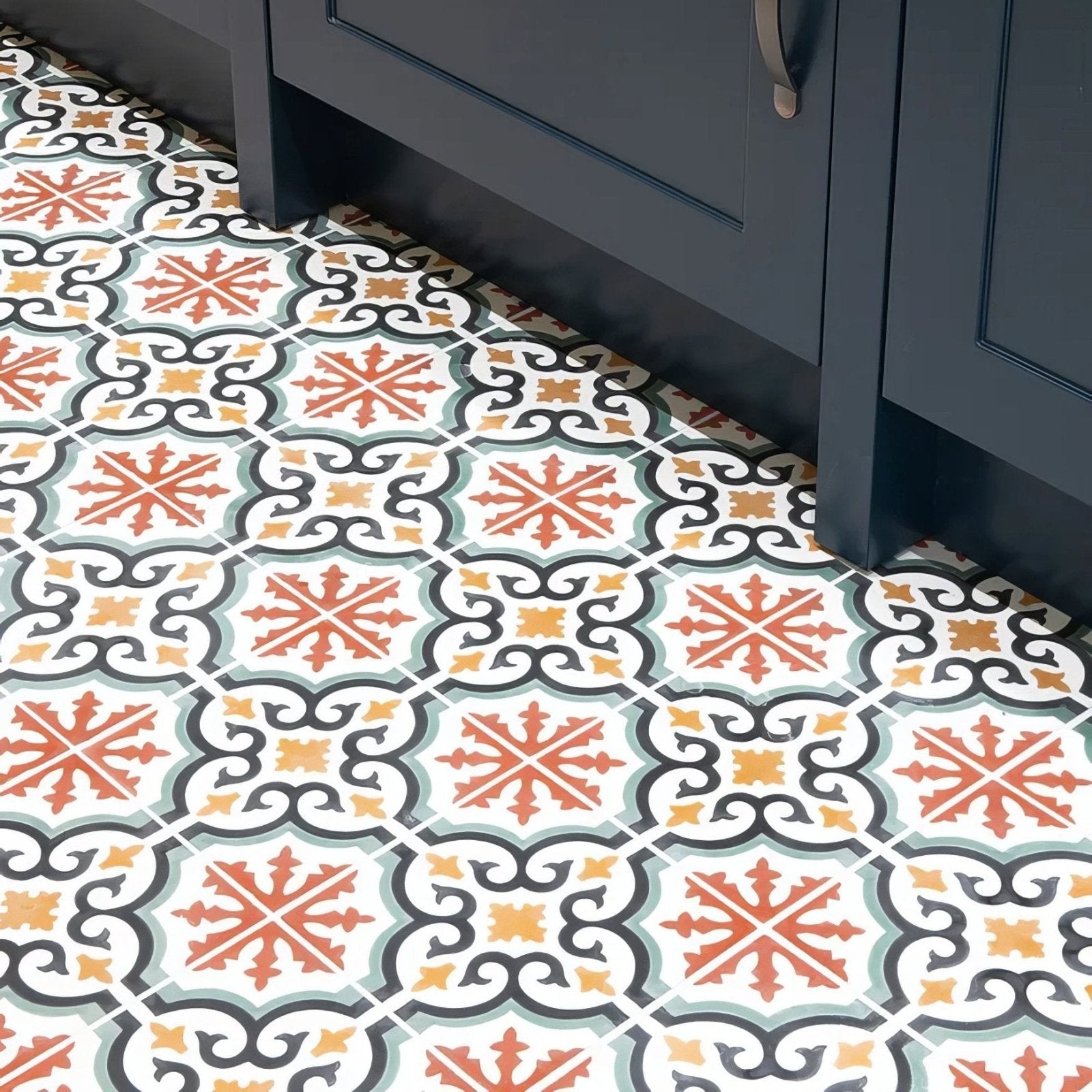 Quintessential porcelain Salisbury patterned ceramic floor tiles with intricate orange yellow black and muted green designs on white background