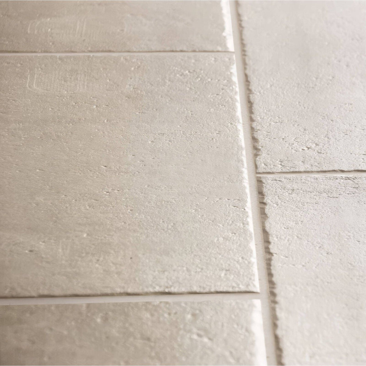 Quintili beige 60 x 90cm light gray textured rectangular tiles with subtle embossed patterns and visible grout lines