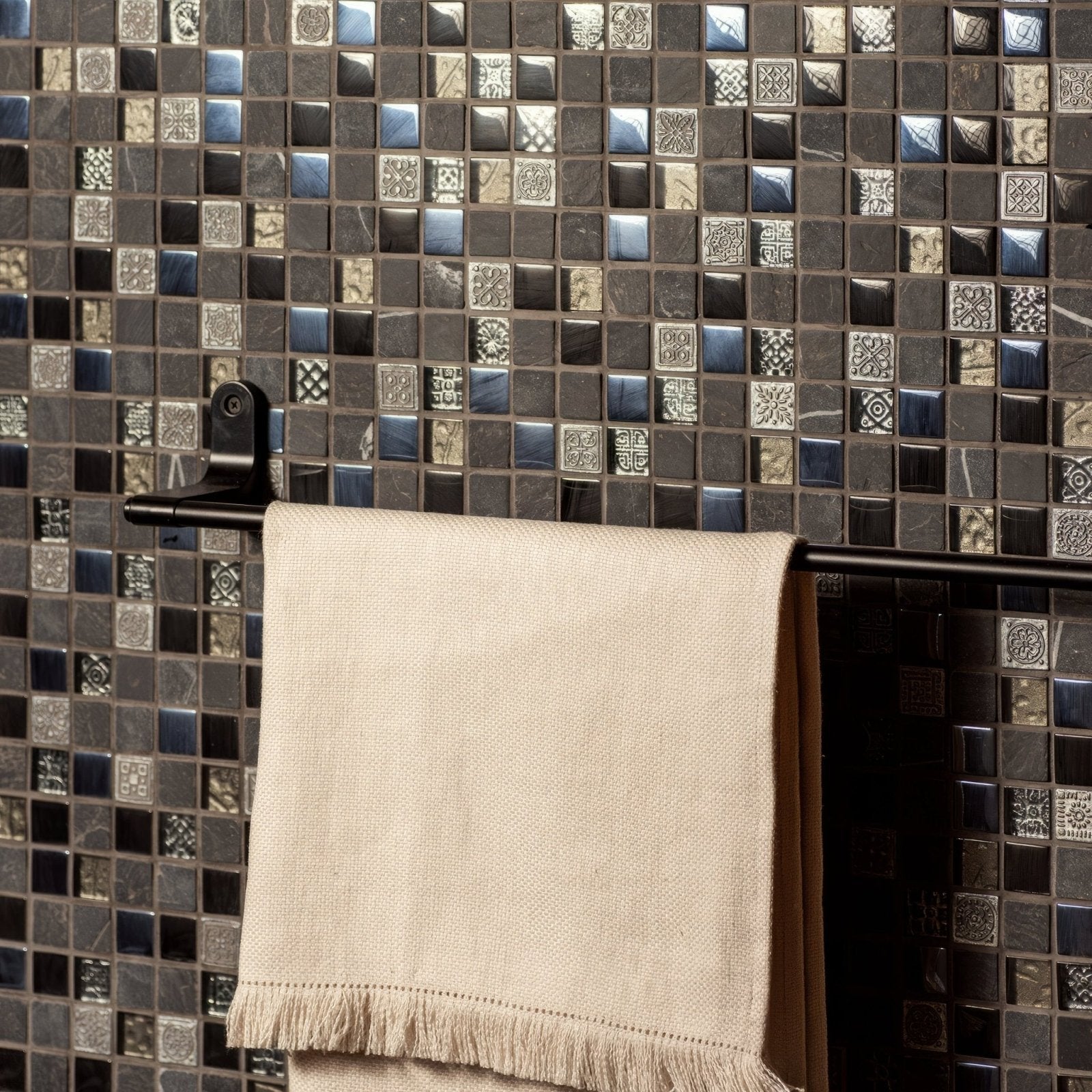 Raipur Mixed Mosaic black and silver glass mosaic with a beige linen towel