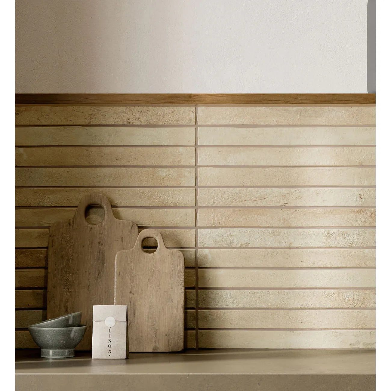 Two rustic wooden cutting boards with natural grain and round handles on ramsbury sand terracotta effect tiles