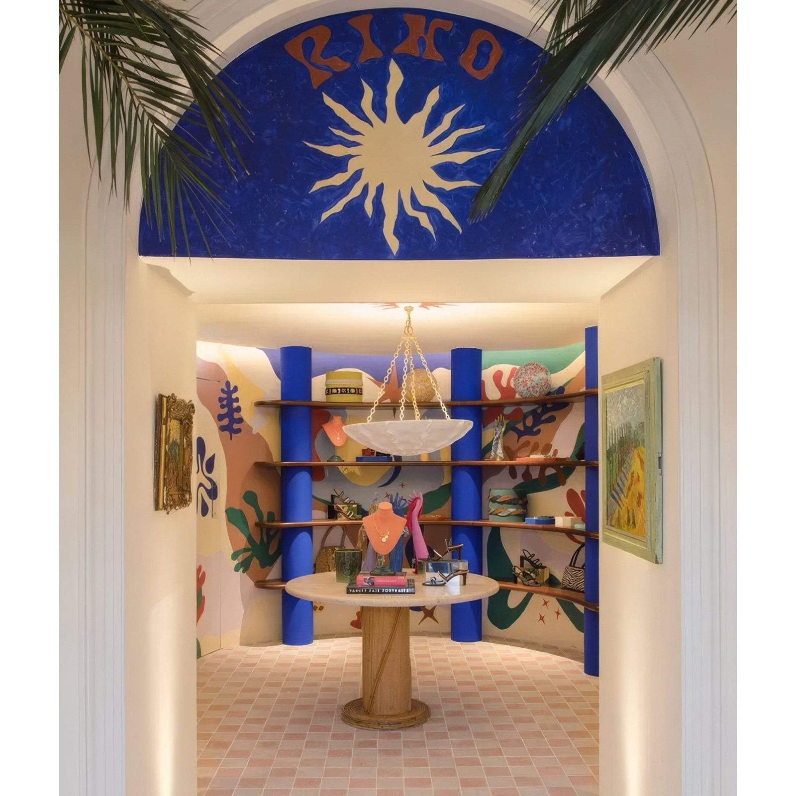 Reform composite stone tumbled bianco in a vibrant interior with blue pillars and shelves displaying various items