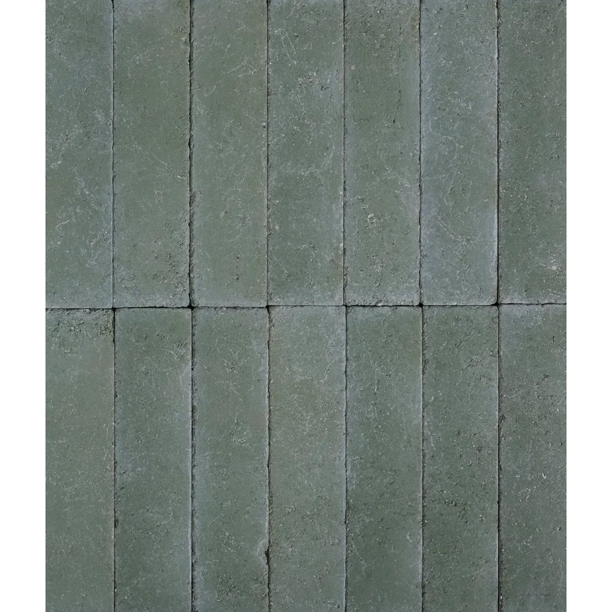 Gray rectangular reform composite stone pavers with textured slightly weathered surface in tumbled leaf green color