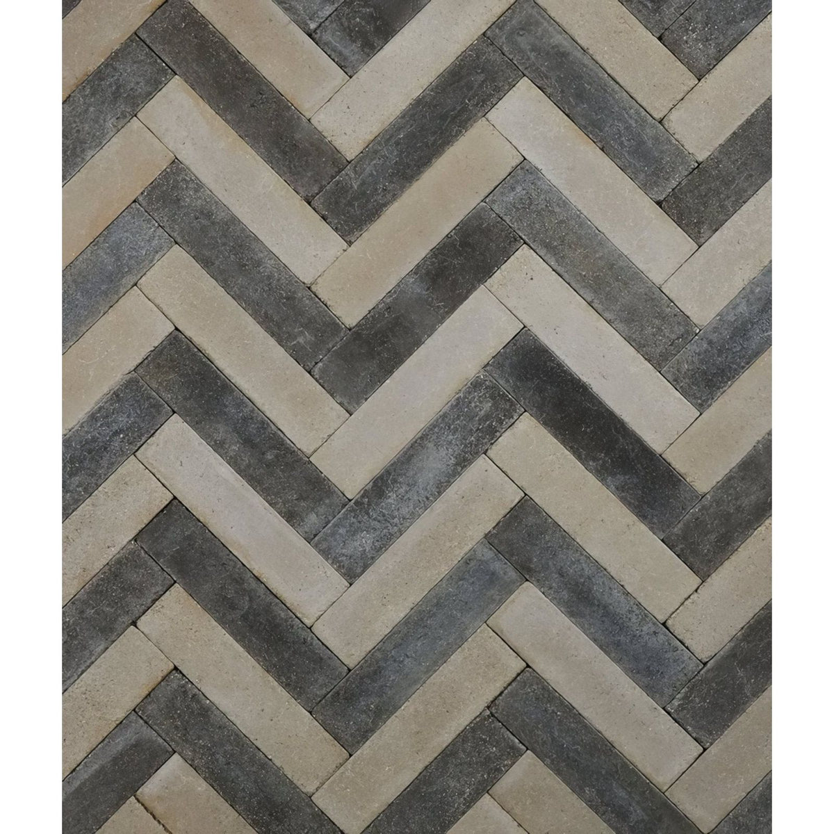 Reform composite stone tumbled nero herringbone-patterned stone tiles in dark gray and beige shades