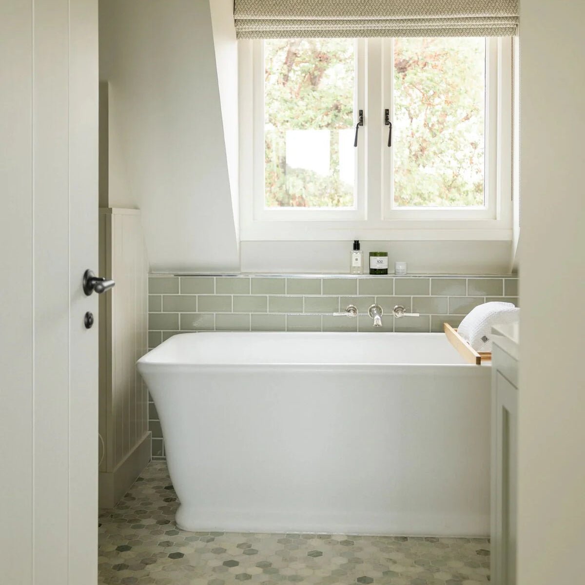 Retro Metro Gloucester Road 7.5 x 15 Glazed Tile sage green glazed tiles with a freestanding bathtub