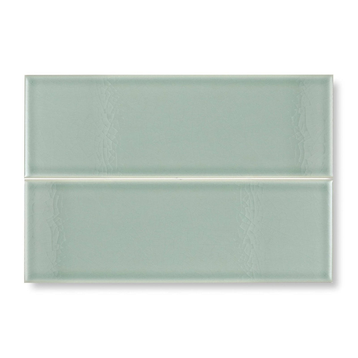 Two rectangular glazed glass tiles in soft sage green with subtle textured patterns retro metro lime house 10 x 30