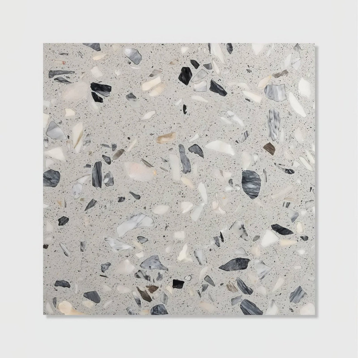 Gray terrazzo castello honed tile featuring a speckled pattern of black white and beige stone fragments