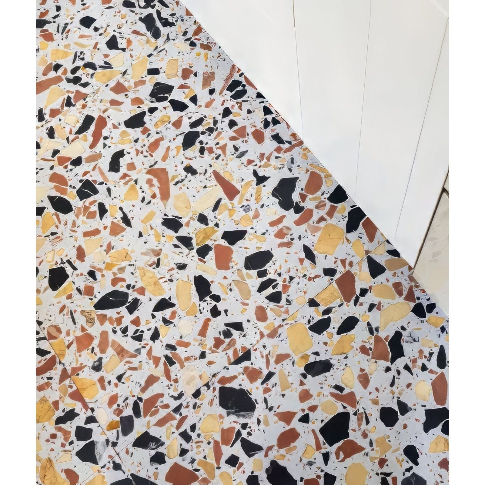 Rialto terrazzo san marco honed floor with mosaic of black yellow and terracotta fragments in white mortar
