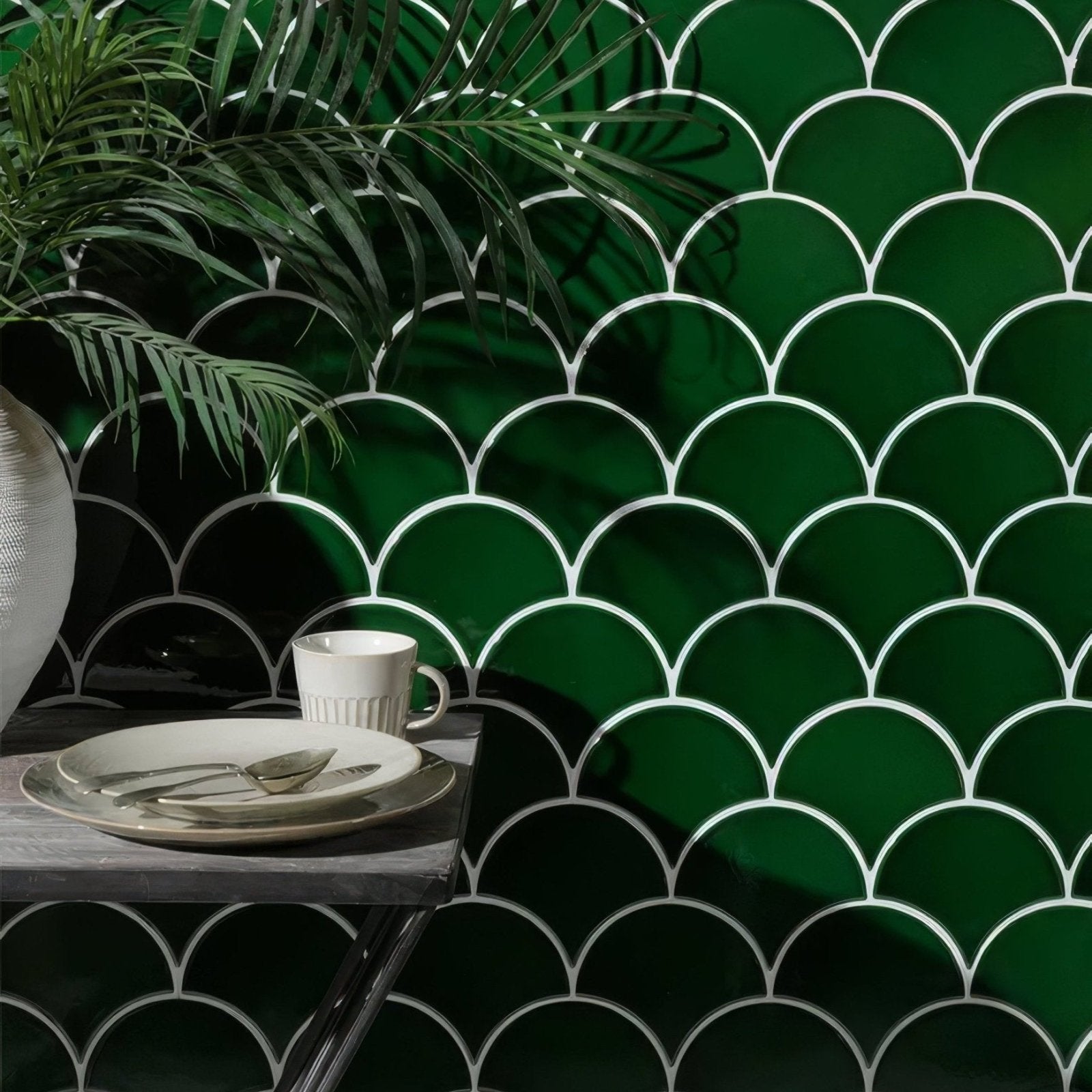 Deep emerald green scalloped ceramic tiles with white grout lines forming a modern Riverlands Scales backsplash
