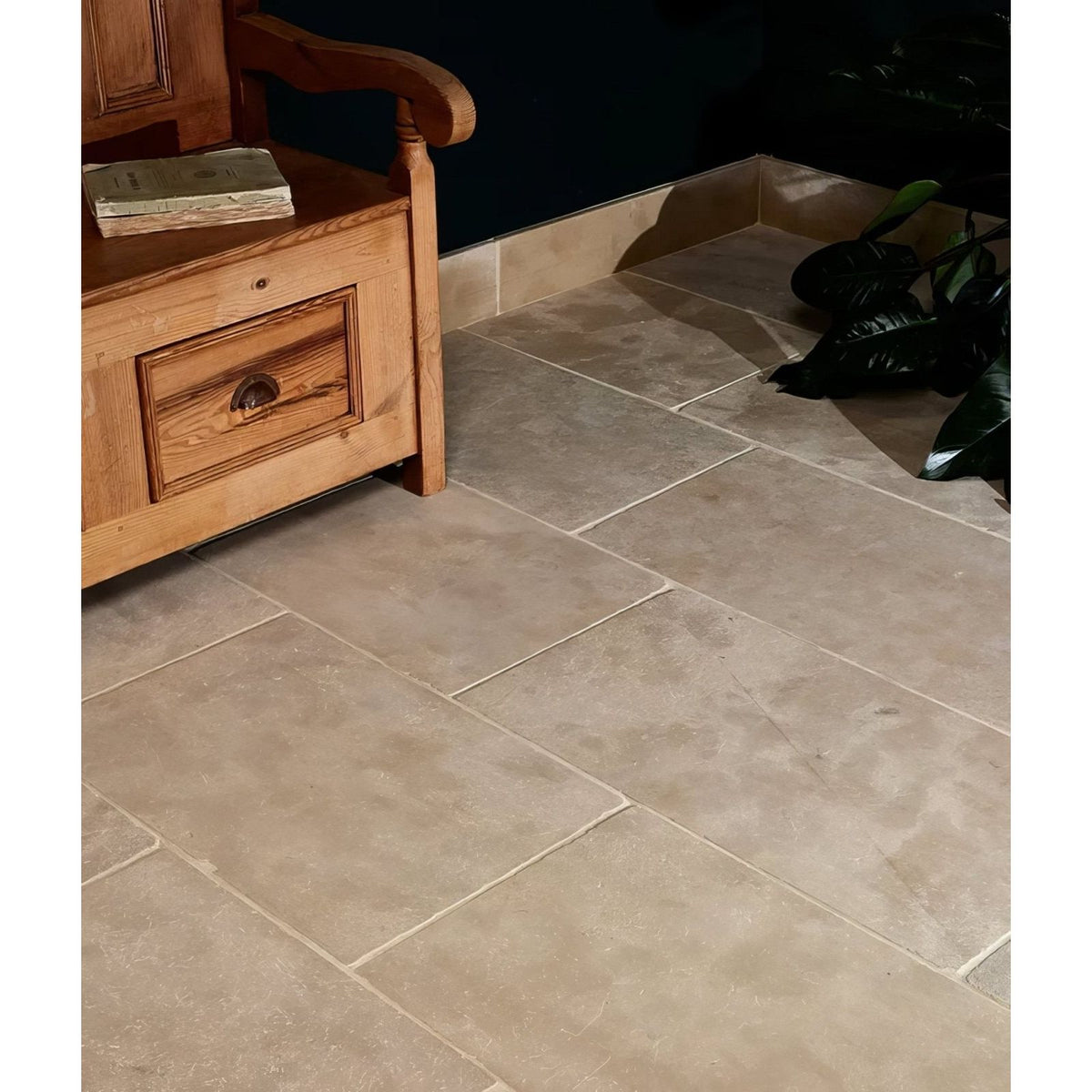 Beige riviera limestone tumbled stone tiles with subtle natural veining and light grout lines for flooring use