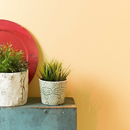 Fired Earth Roman Ochre Paint warm ochre paint shown with a distressed ceramic planter