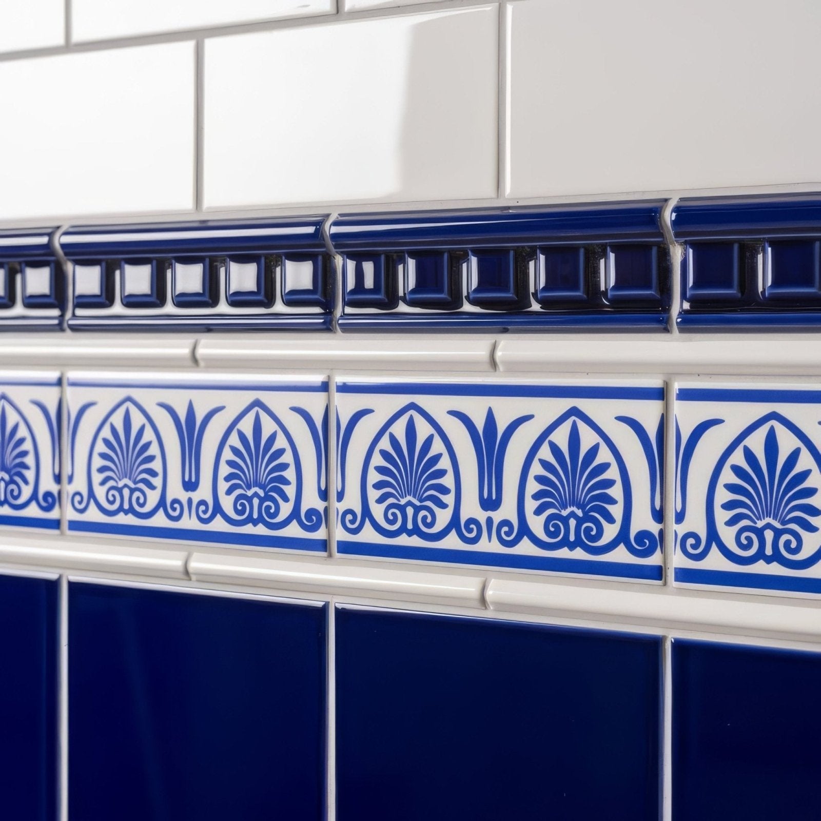 Royal blue dentil moulding featuring blue and white ceramic tile border with ornate foliate patterns