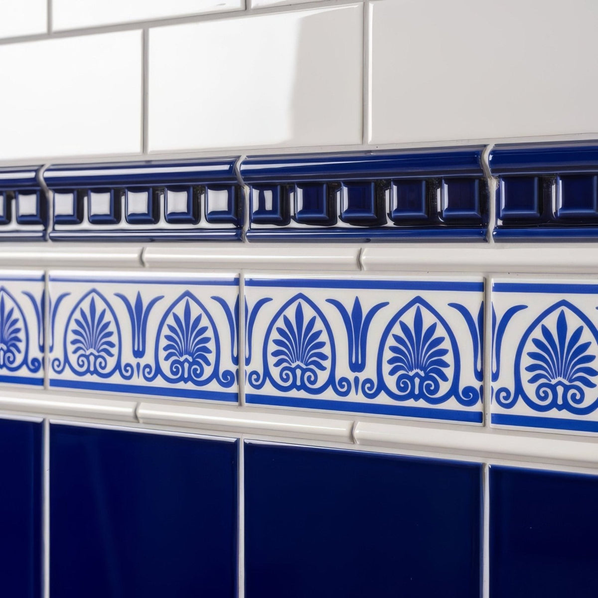 Royal blue dentil moulding featuring blue and white ceramic tile border with ornate foliate patterns