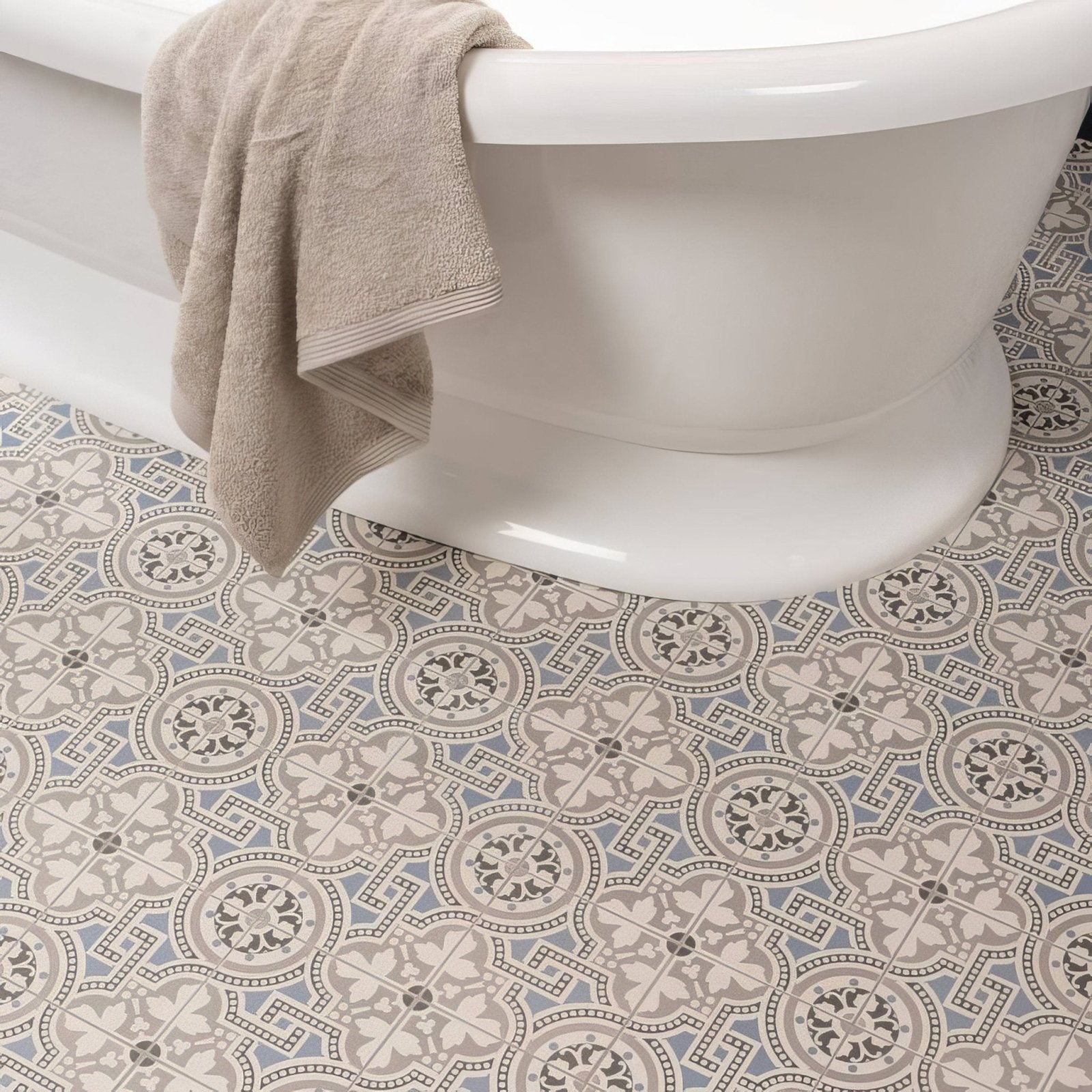 Beige towel draped over the edge of a white bathtub in Salisbury Blue on Dover White bathroom setting