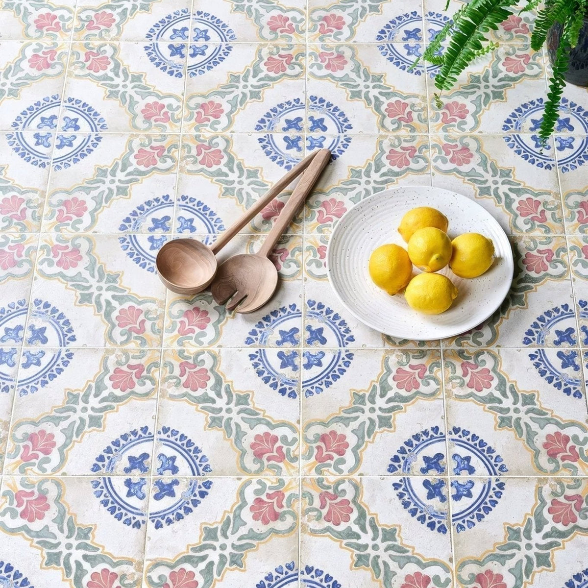 White speckled ceramic sardinia porcelain dragonetti plate holding five bright yellow lemons