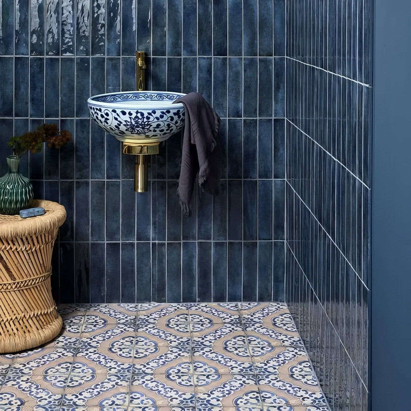 Sardinia Porcelain Masseria blue and terracotta patterned tiles with a wall-mounted sink and gold tap