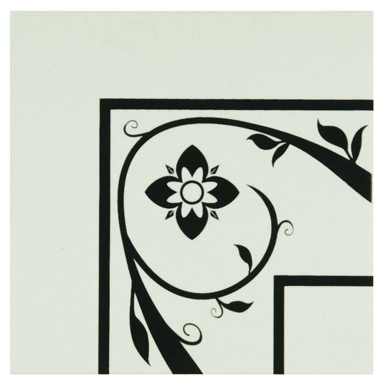 Saxon corner black floral and vine decal with central stylized flower on a dover white light-colored surface