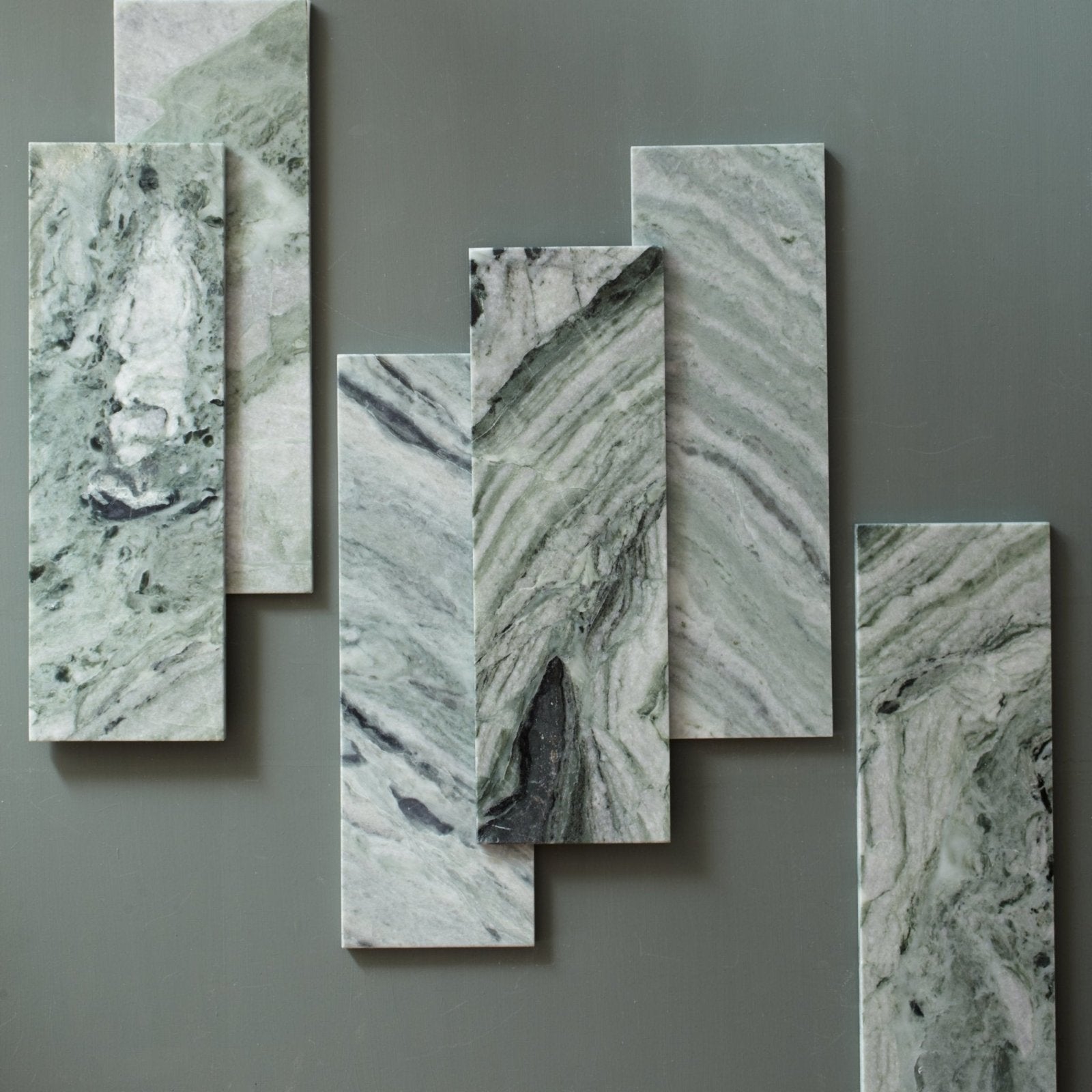 Modern abstract wall art with five green and white marble panels featuring dark veining seaspray green marble tile 10 x 30cm