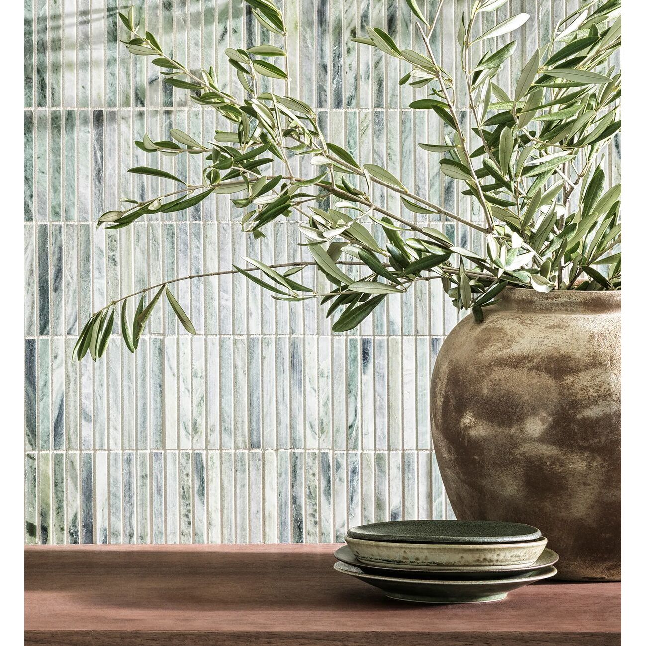 Earthy-toned ceramic seaspray green stacked mosaic vase holding olive branches for home decor