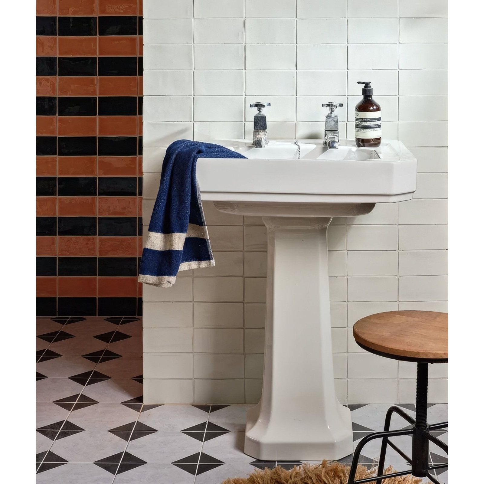 White ceramic pedestal sink with dual basins and chrome faucets in seaton ceramic ice cream design