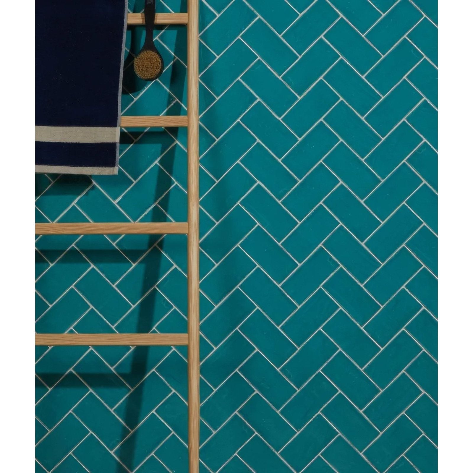 Seaton ceramic lagoon vibrant teal herringbone patterned ceramic tiles with crisp white grout lines