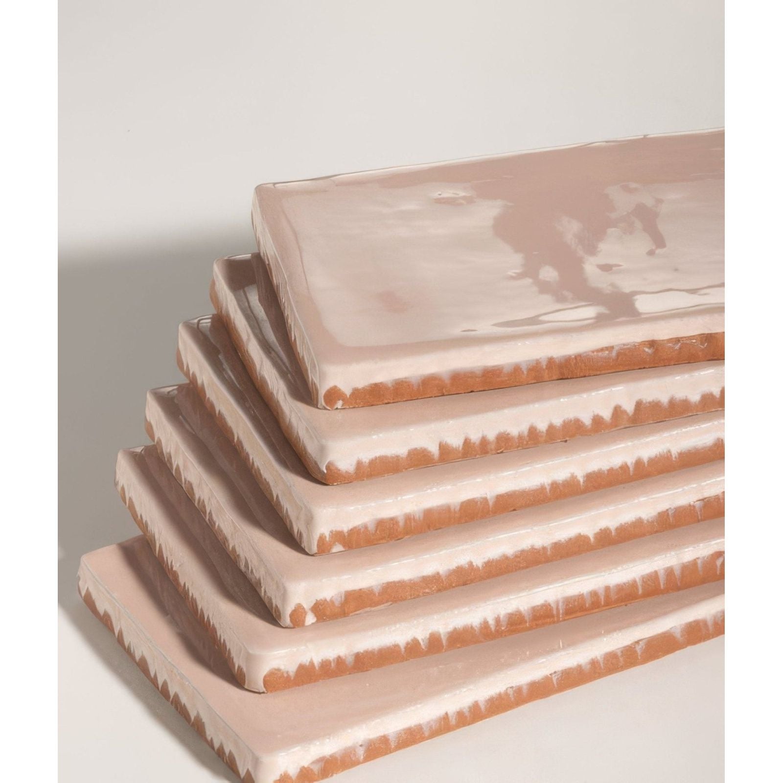 Stacked rectangular seaton ceramic pink sands tiles with matte blush pink glaze and exposed terracotta edges