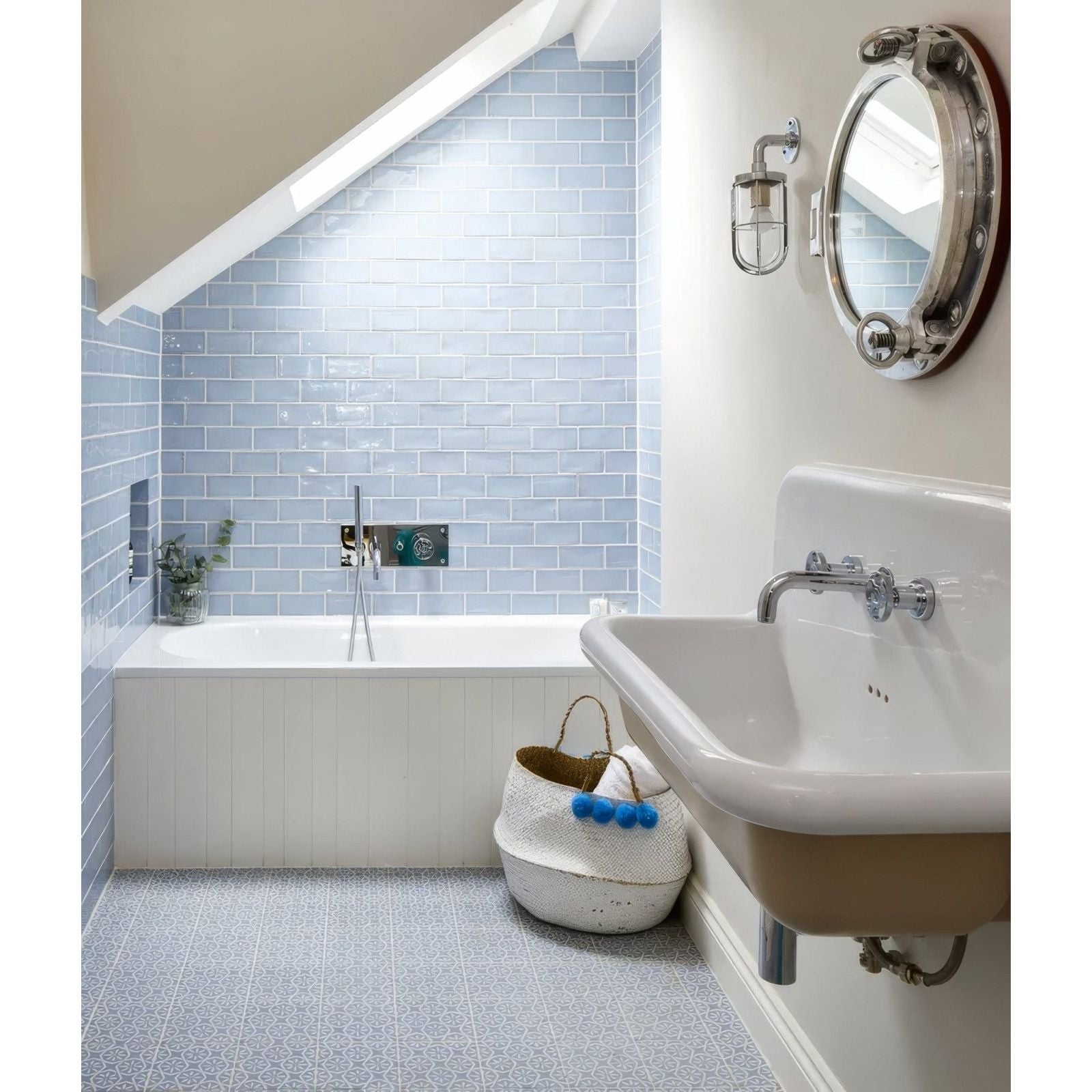 White woven basket with blue pom-poms featured in Seaton ceramic sky product design