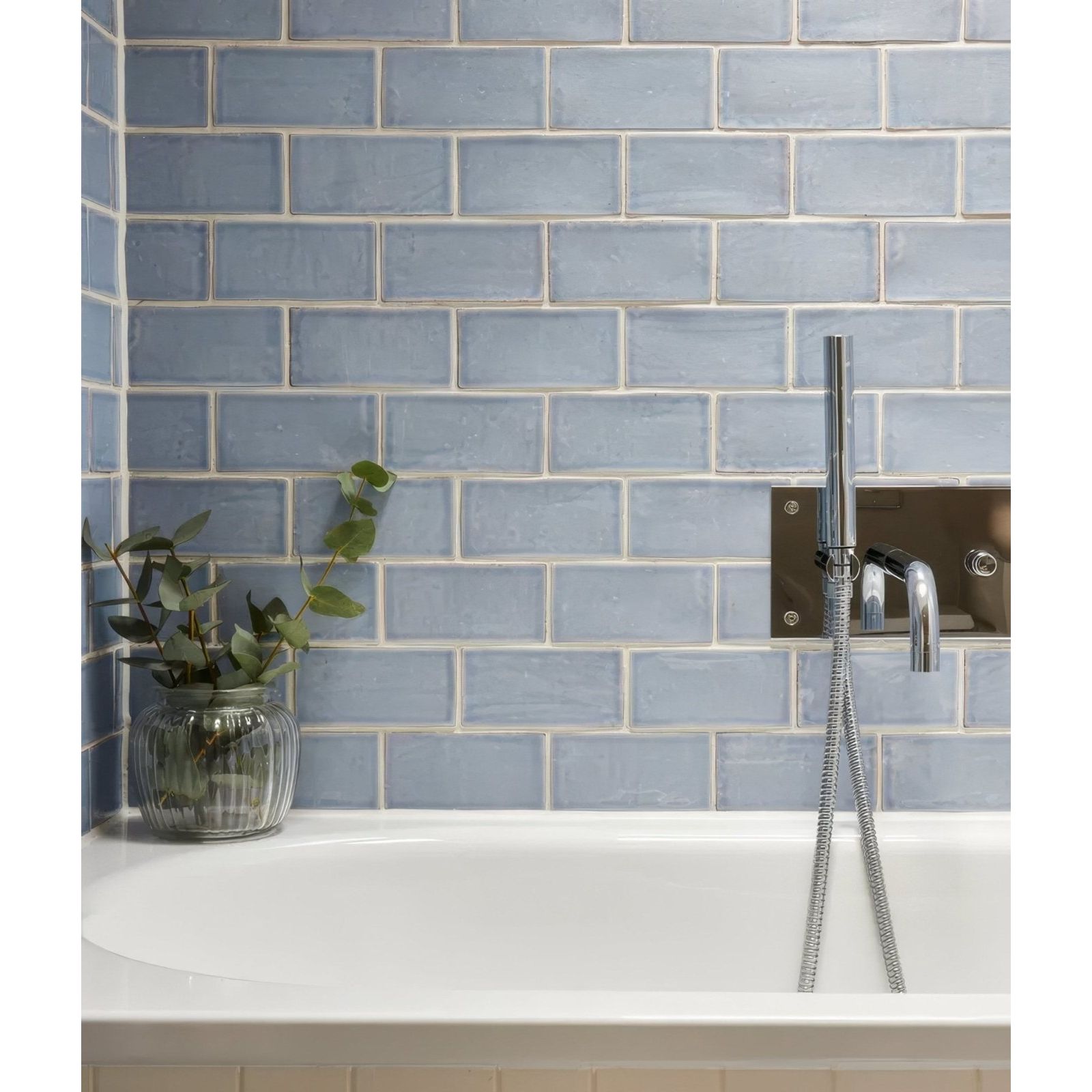 Light blue rectangular ceramic subway tiles with subtle texture and white grout from seaton ceramic sky collection
