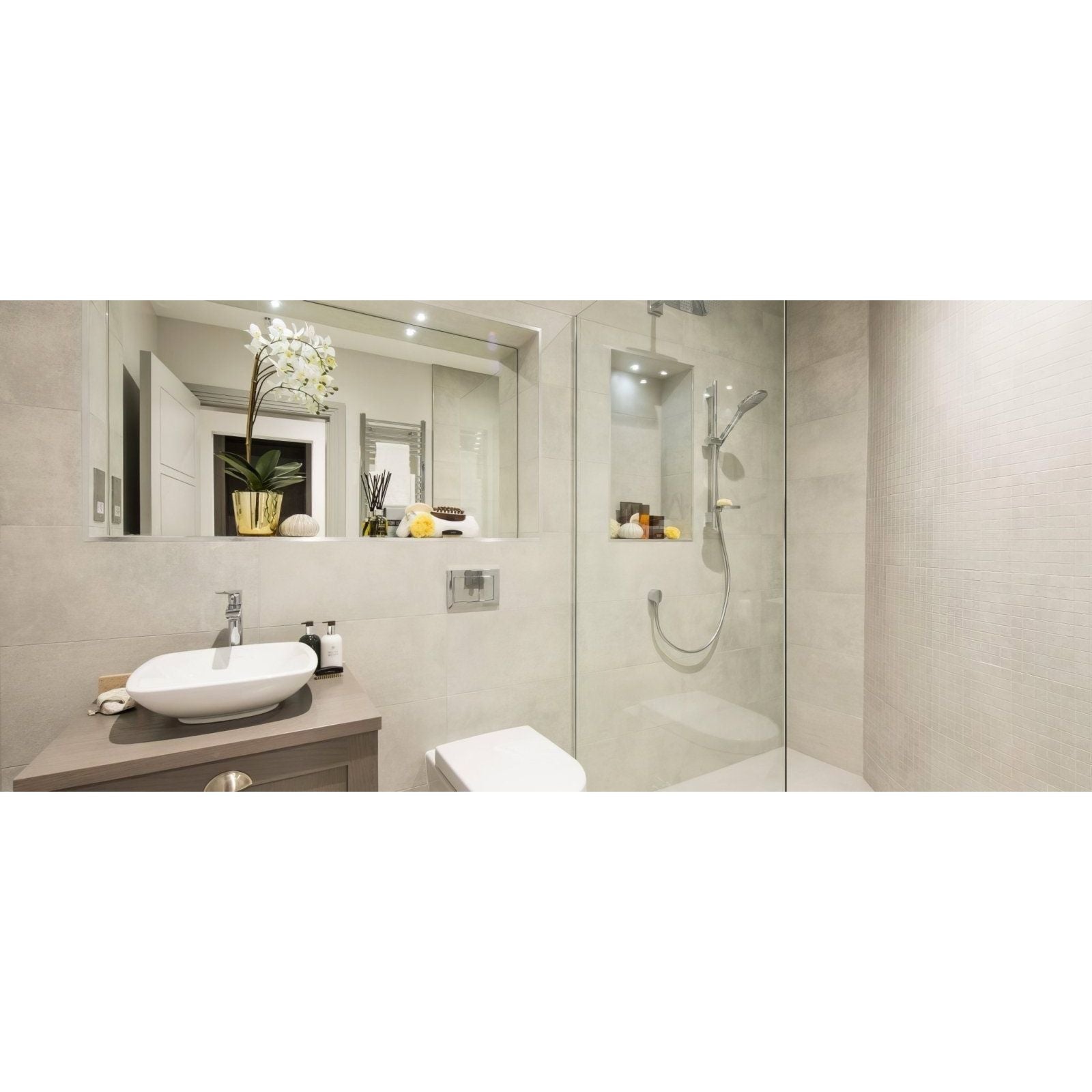 Modern white ceramic vessel sink with sleek chrome faucet on matte gray vanity in select nebbia mosaic style