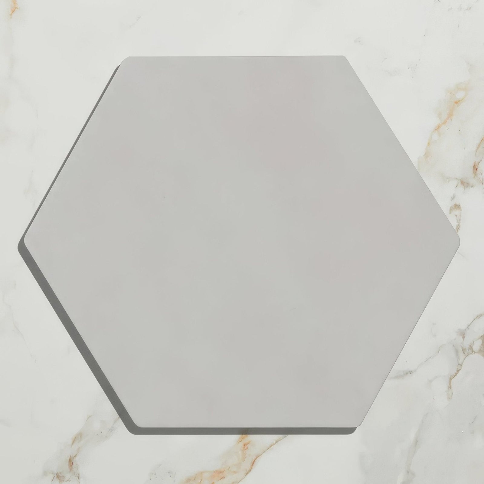 A sleek matte finished hexagonal porcelain tile in soft gray from the Shadow White Field collection