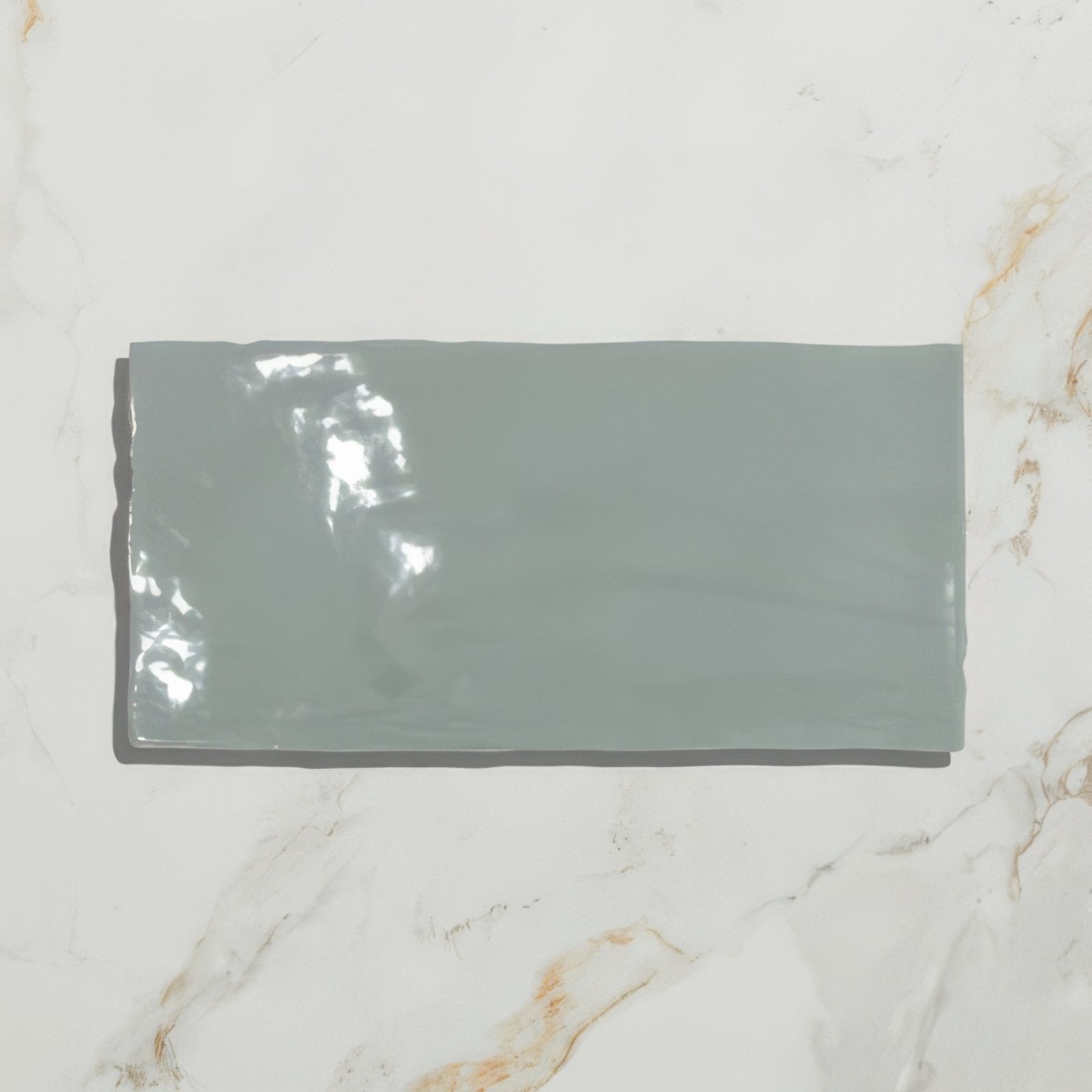 A sleek matte-finished gray ceramic rectangular tile with subtle glossy reflections from shorelin ceramic sea kale